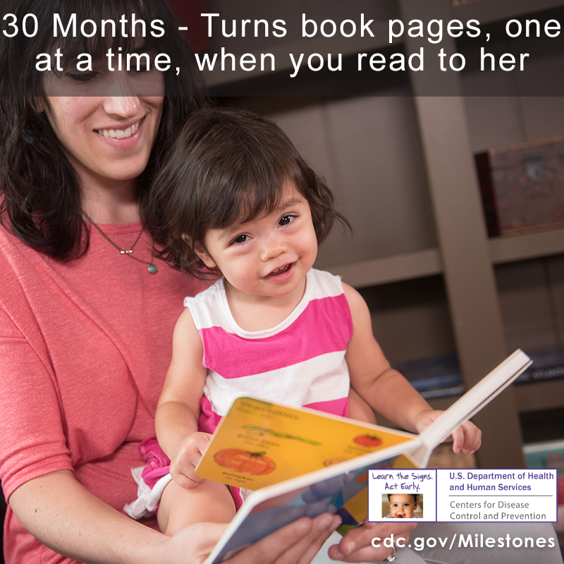 The girl in this photo is sitting on her mother's lap and is turning book pages one at a time, a 30 month milestone.