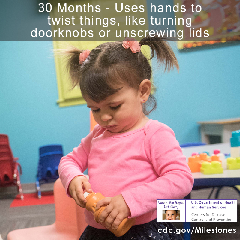 30 month milestone with an image of a girl trying to twist a lid off of a bottle.