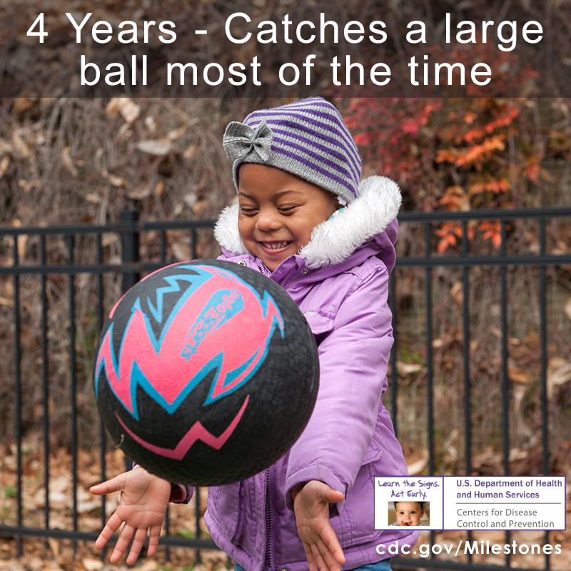 The child in this photo is showing that she can catch a large ball most of the time, a 4-year movement/physical development milestone.