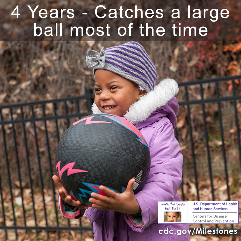 The child in this photo is showing that she can catch a large ball most of the time, a 4-year movement/physical development milestone.