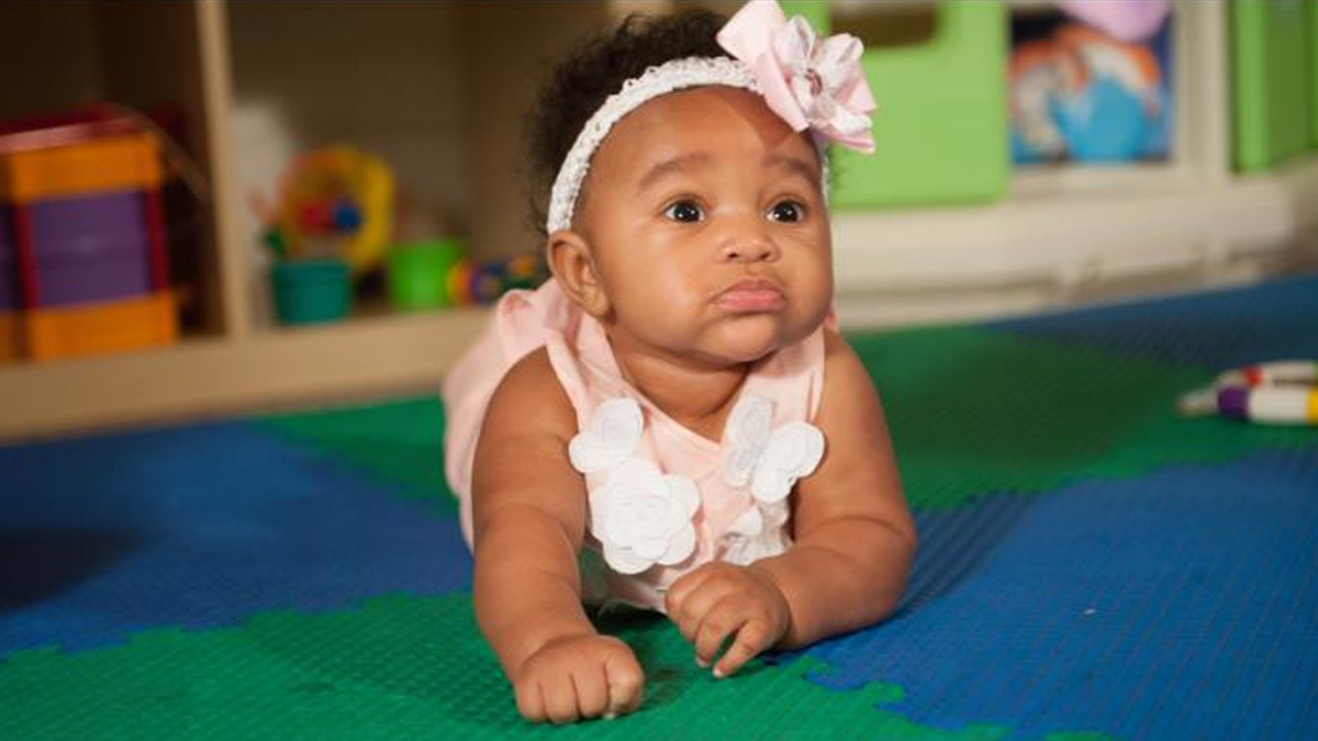 4 months girl laying on ground