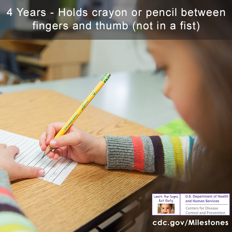 The girl in this photo is holding a pencil and drawing, a 4 year milestone.