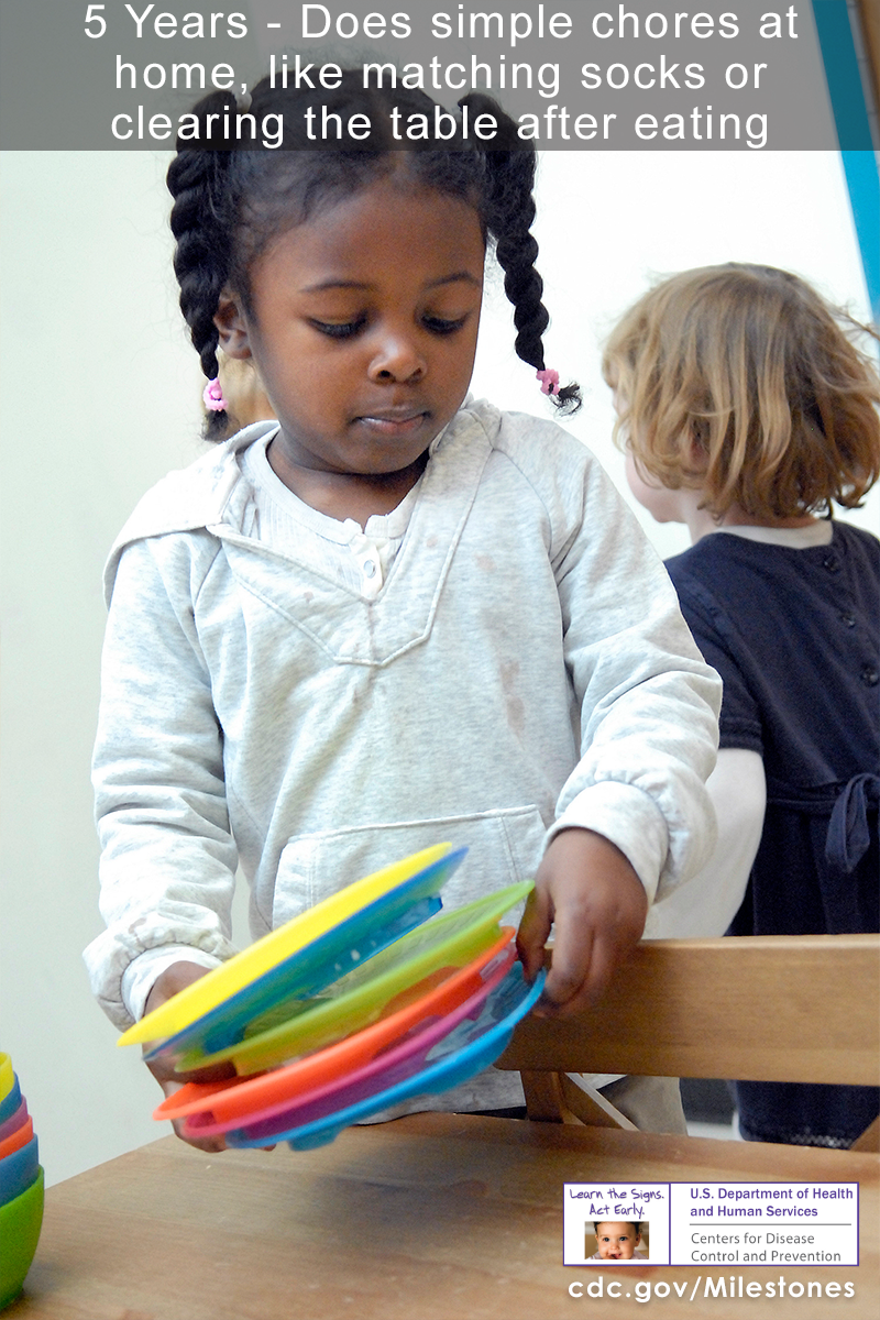The girl in this photo is stacking colorful plates.