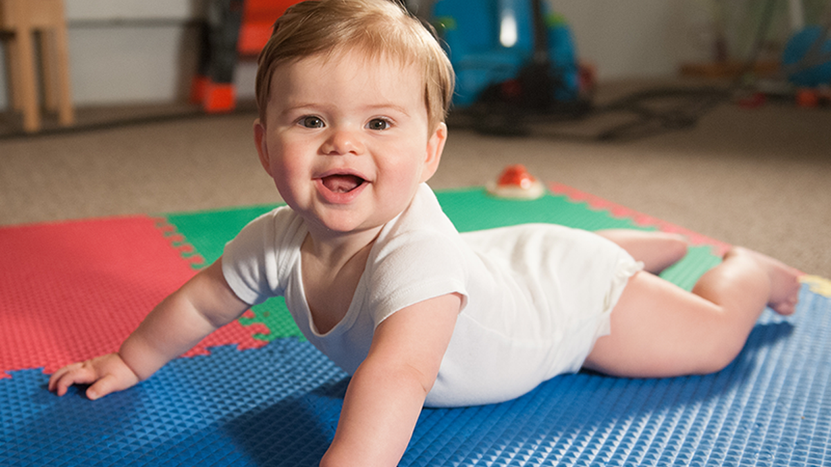 6 month baby lying on ground