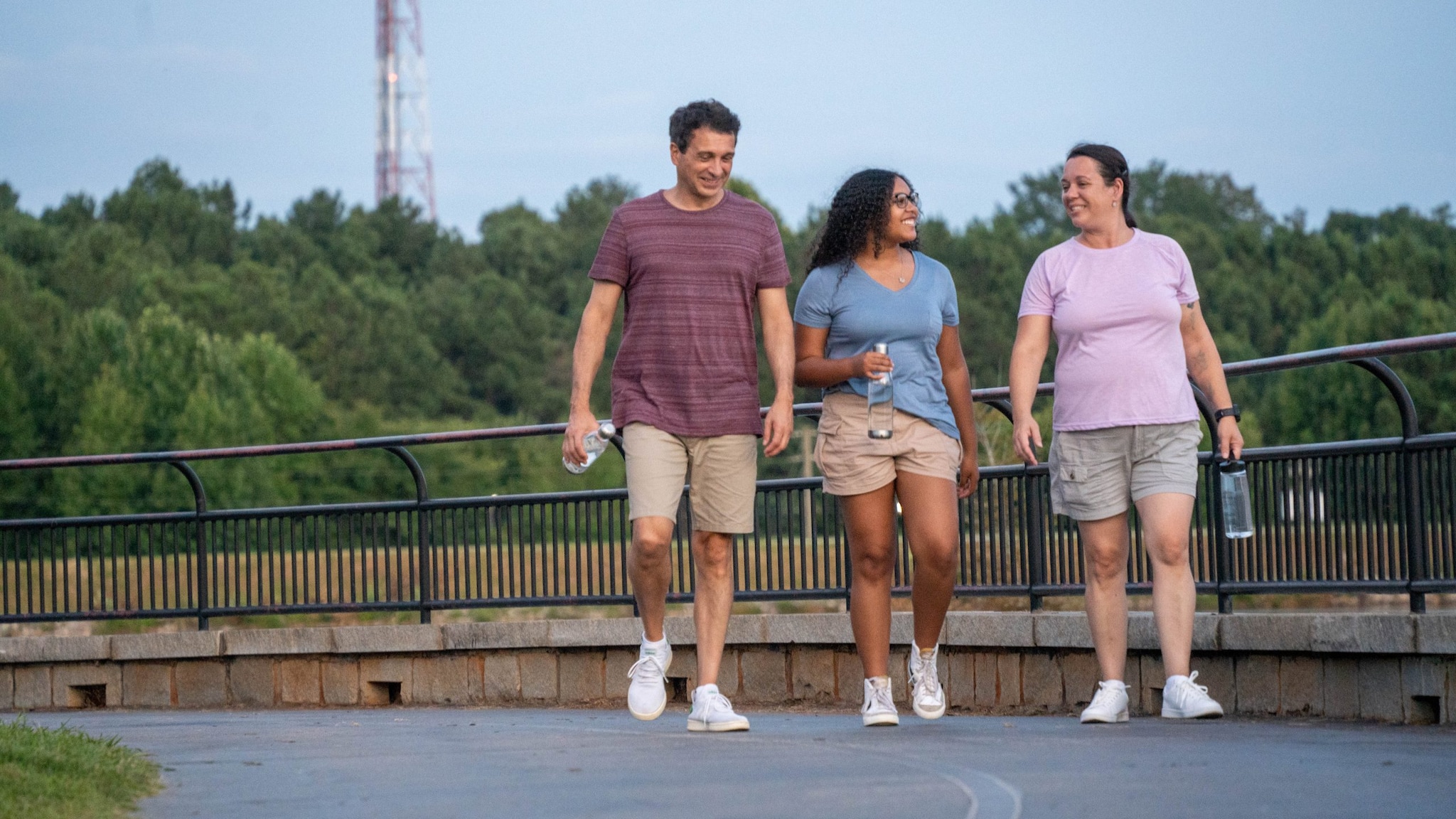 Young adults walking on a paved trail
