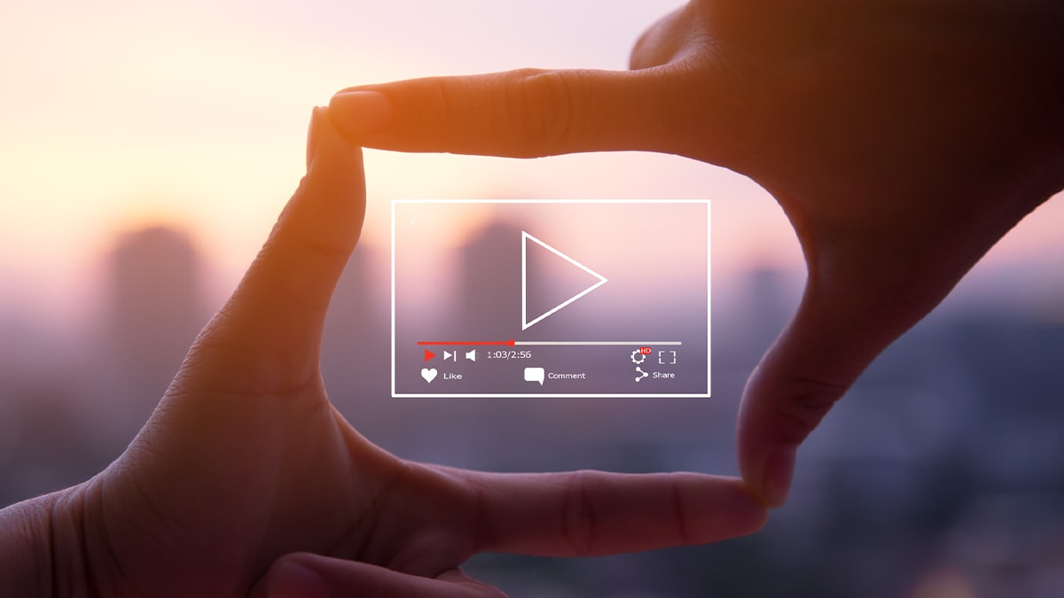Play video icon surrounded by hands