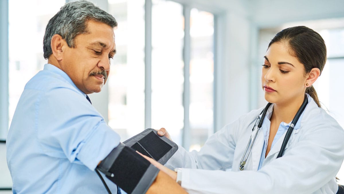 Doctor checking patient's blood pressure