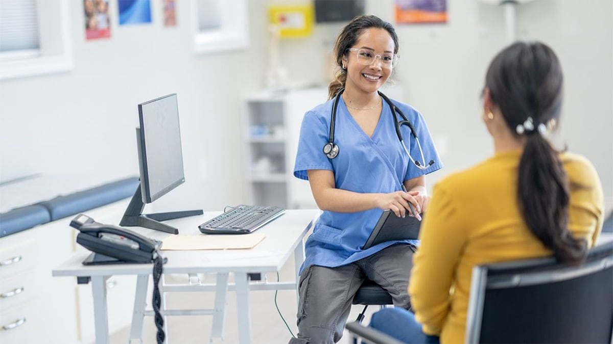 A healthcare worker talking to a patient