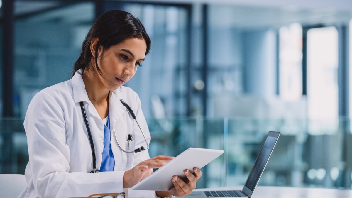 A clinician taking notes on a recent patient encounter, including logging patient medications