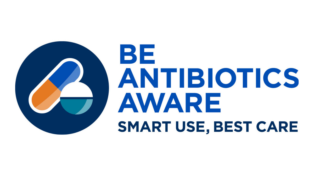 Image includes large dark blue circle with blue and orange pill, and white and blue tablet inside. “Be Antibiotics Aware: Smart Use, Best Care” written to the right of image in blue.