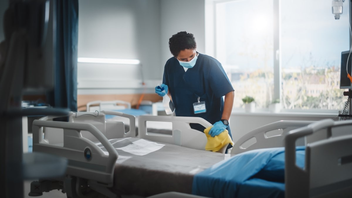 Healthcare worker cleaning room