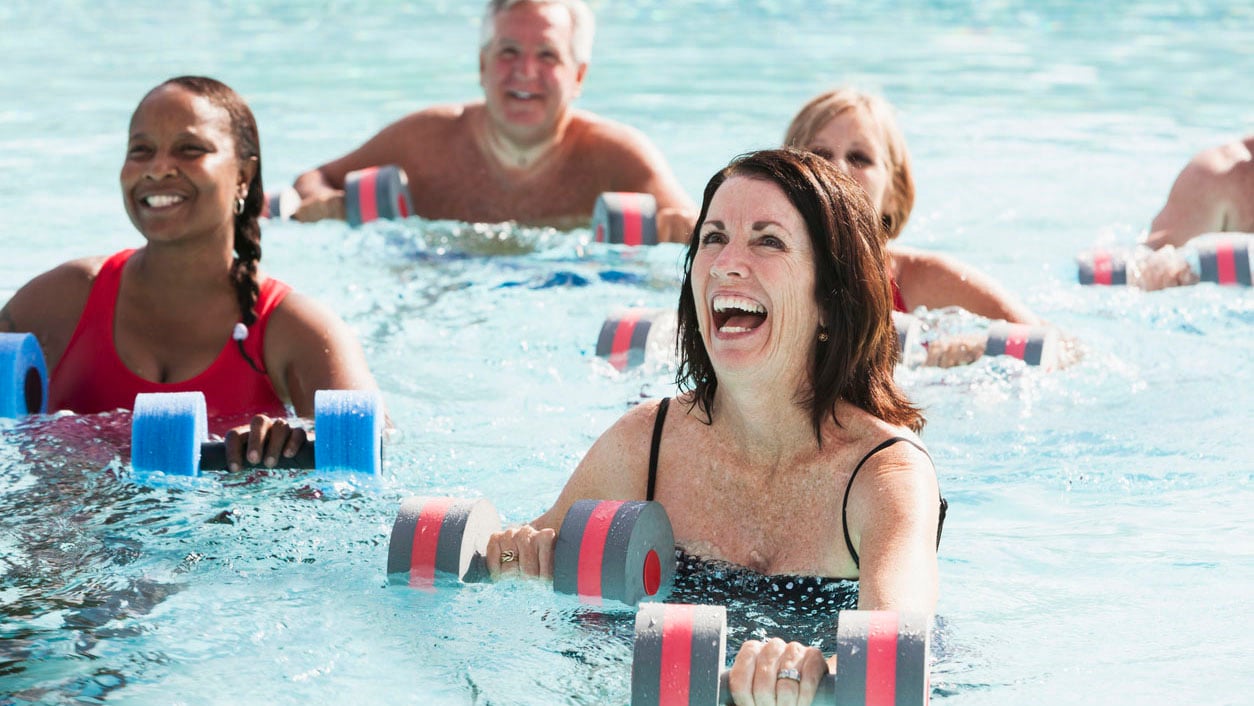 Group of adults enjoying water aerobics.