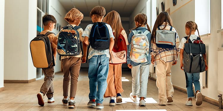 Group of students walking in a school hallway.