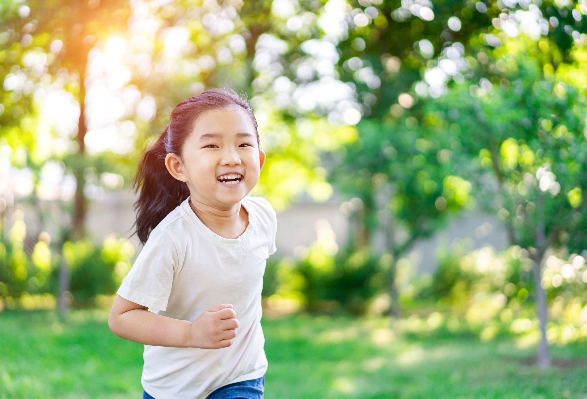 Young girl running in yard