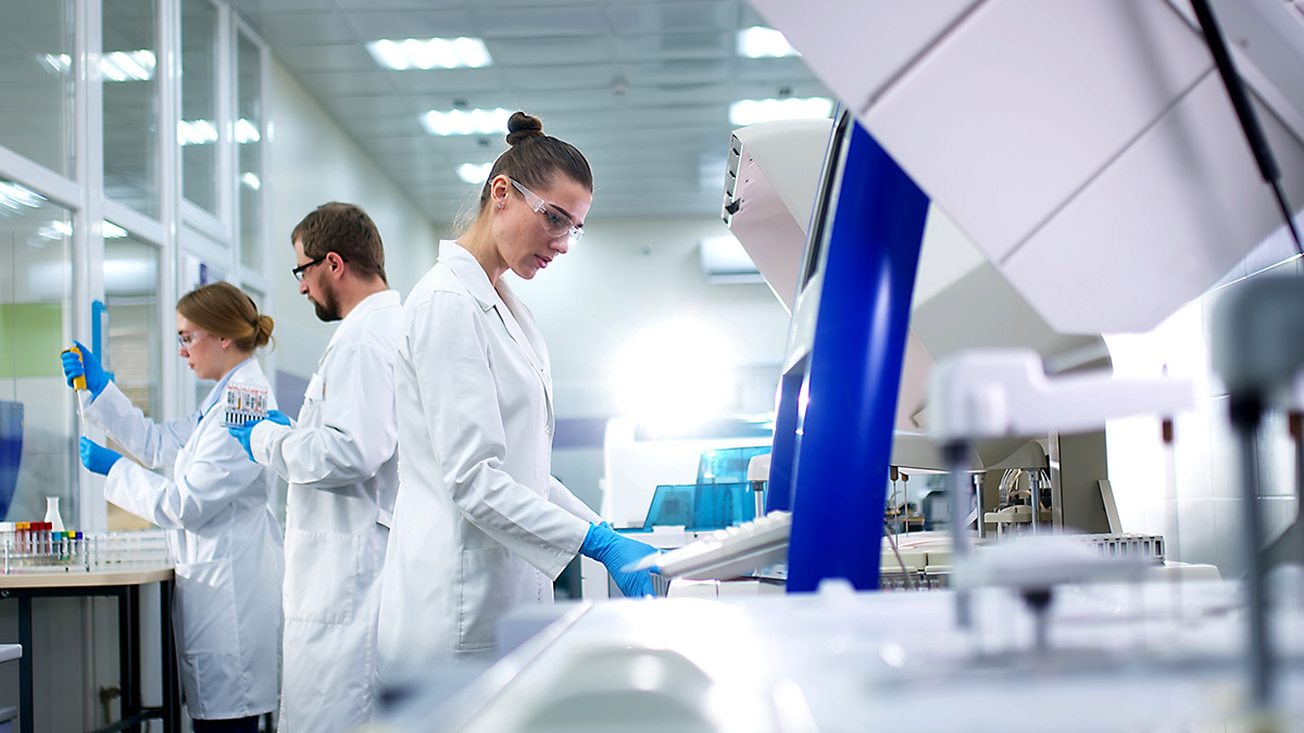 Lab professional using machines to test virus