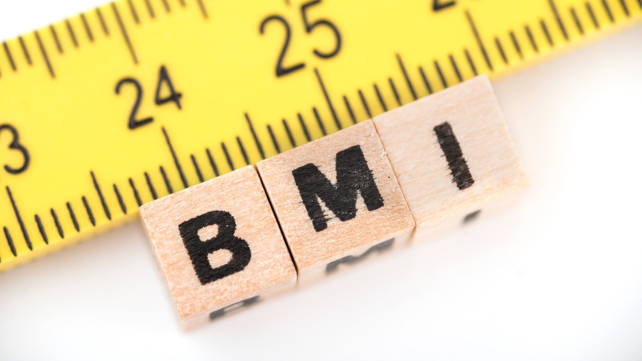 Block letters spelling BMI and a tape measure