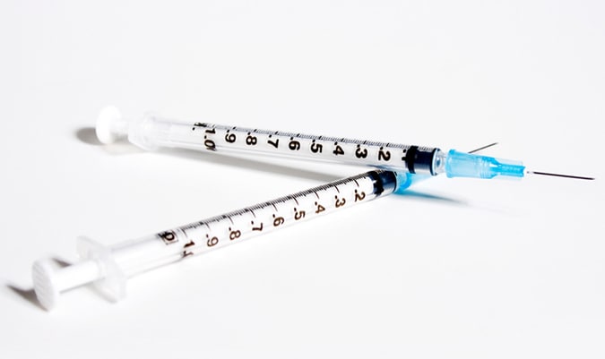 Two syringes on white background