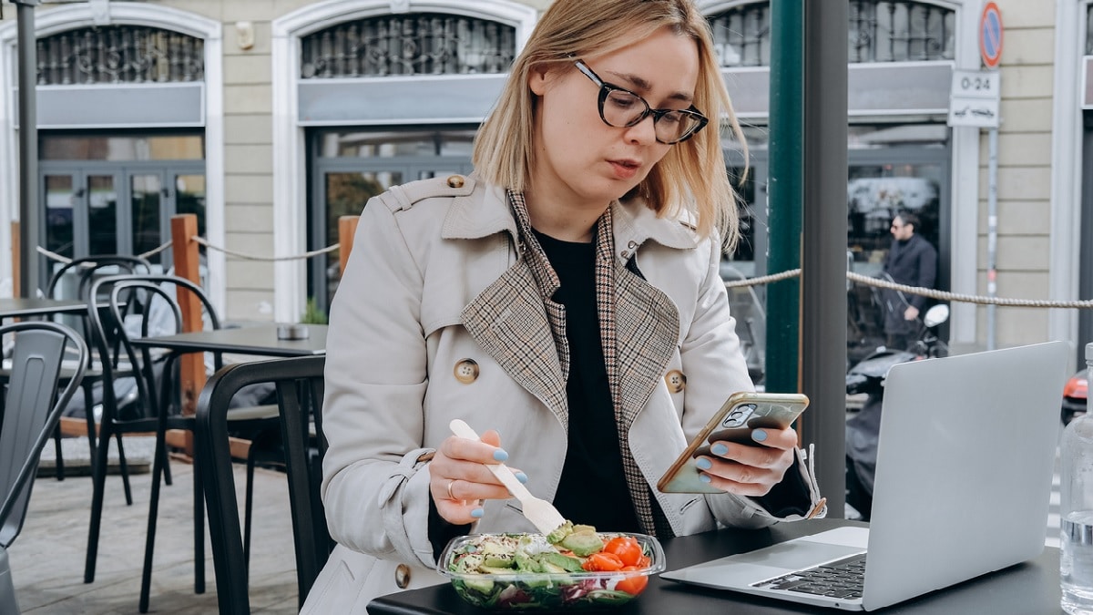 Photo of a woman eating a salad