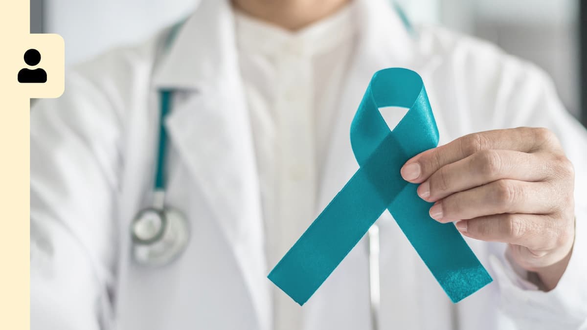 A healthcare provider holding a large ribbon.