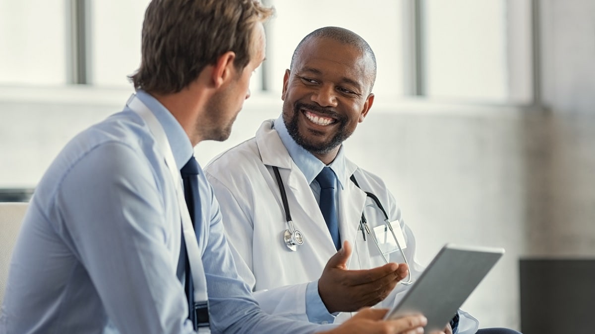 A consultant provides feedback to a doctor