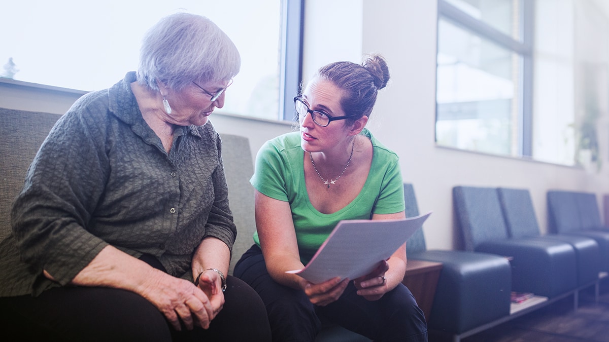 Woman shares information with older woman