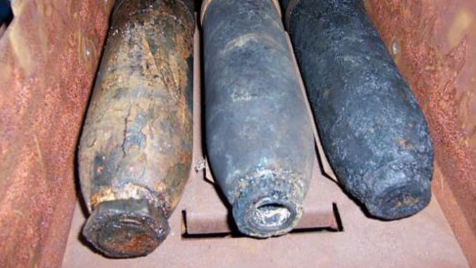 Three weapons in a box that were recovered from the ocean.