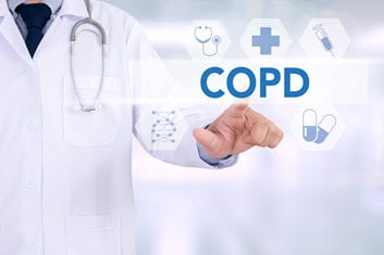Doctor touching transparent screen that says 'COPD'