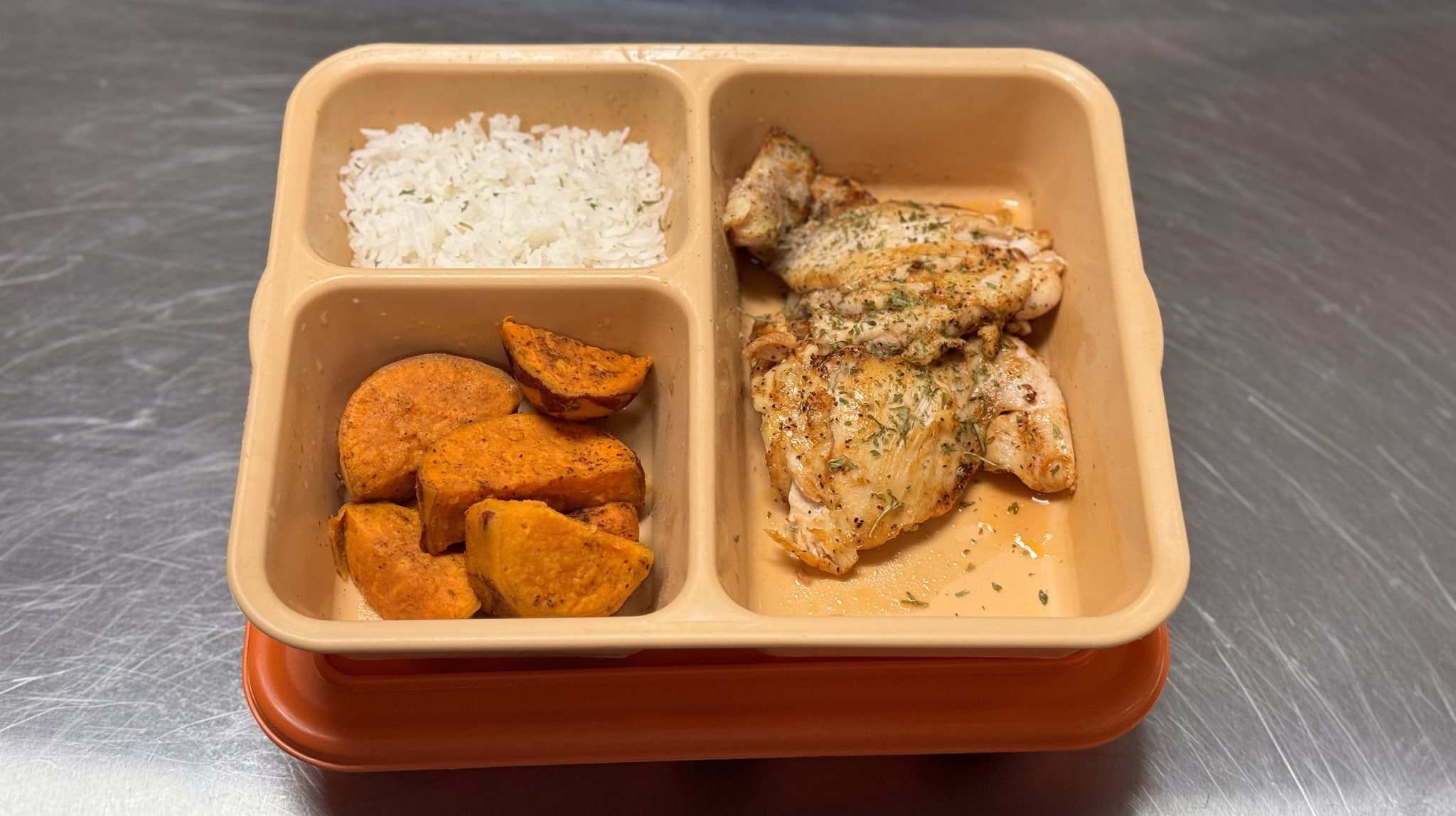 Chicken, sweet potato and rice in a covered try for a segregation unit.