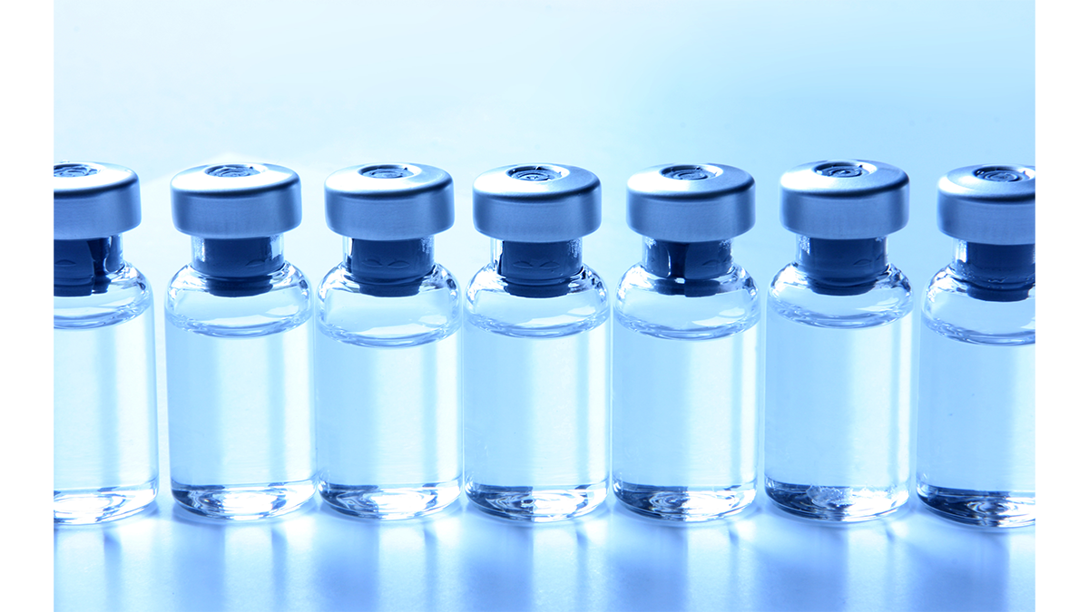 A line of vials containing clear liquid on a blue background.