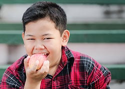 صبي يأكل تفاحة