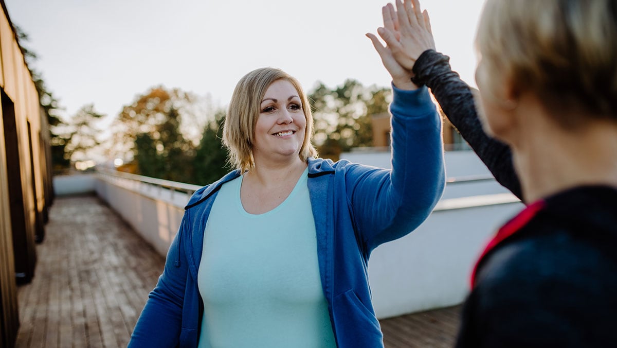 woman high fiving an exercise partner