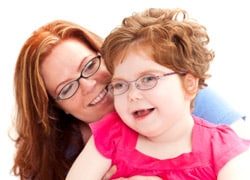 A mother holds a daughter with dsiabilities.