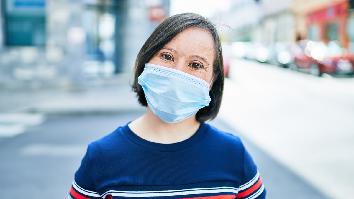 Woman with Down Syndrome wearing a mask.