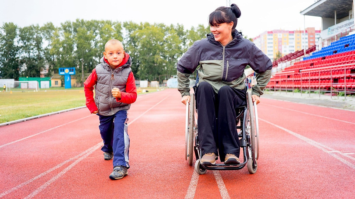 Woman in a wheelchair with a child getting ready to run