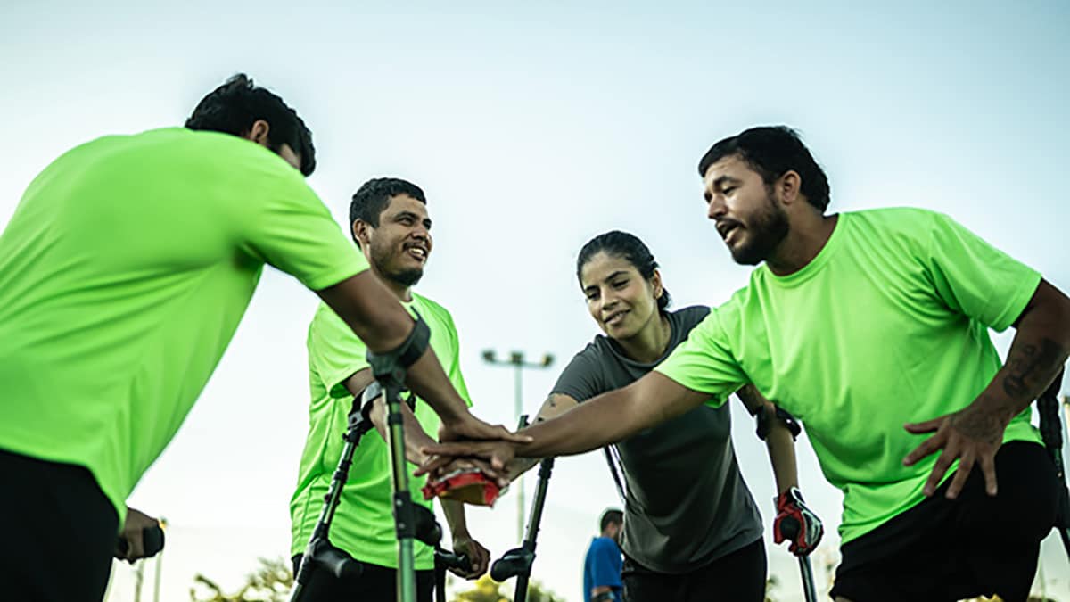 Teammates with hands together cheering