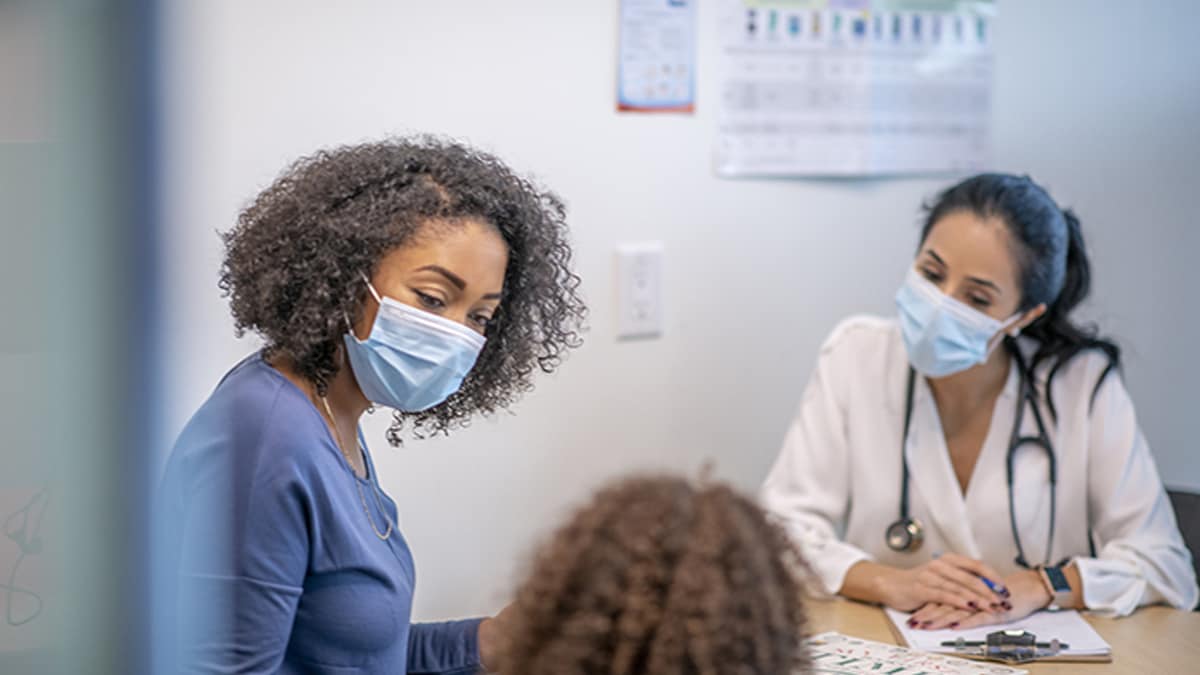 mother with her daughter at the doctor's office