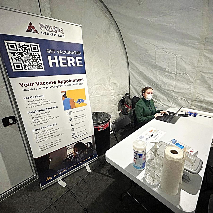 EIS officer Chelsea Lutz, PhD, MPH (EIS Class of 2023) enters data during a vaccination clinic at an intake facility during a measles outbreak associated with a shelter in Chicago, Illinois in March 2023.