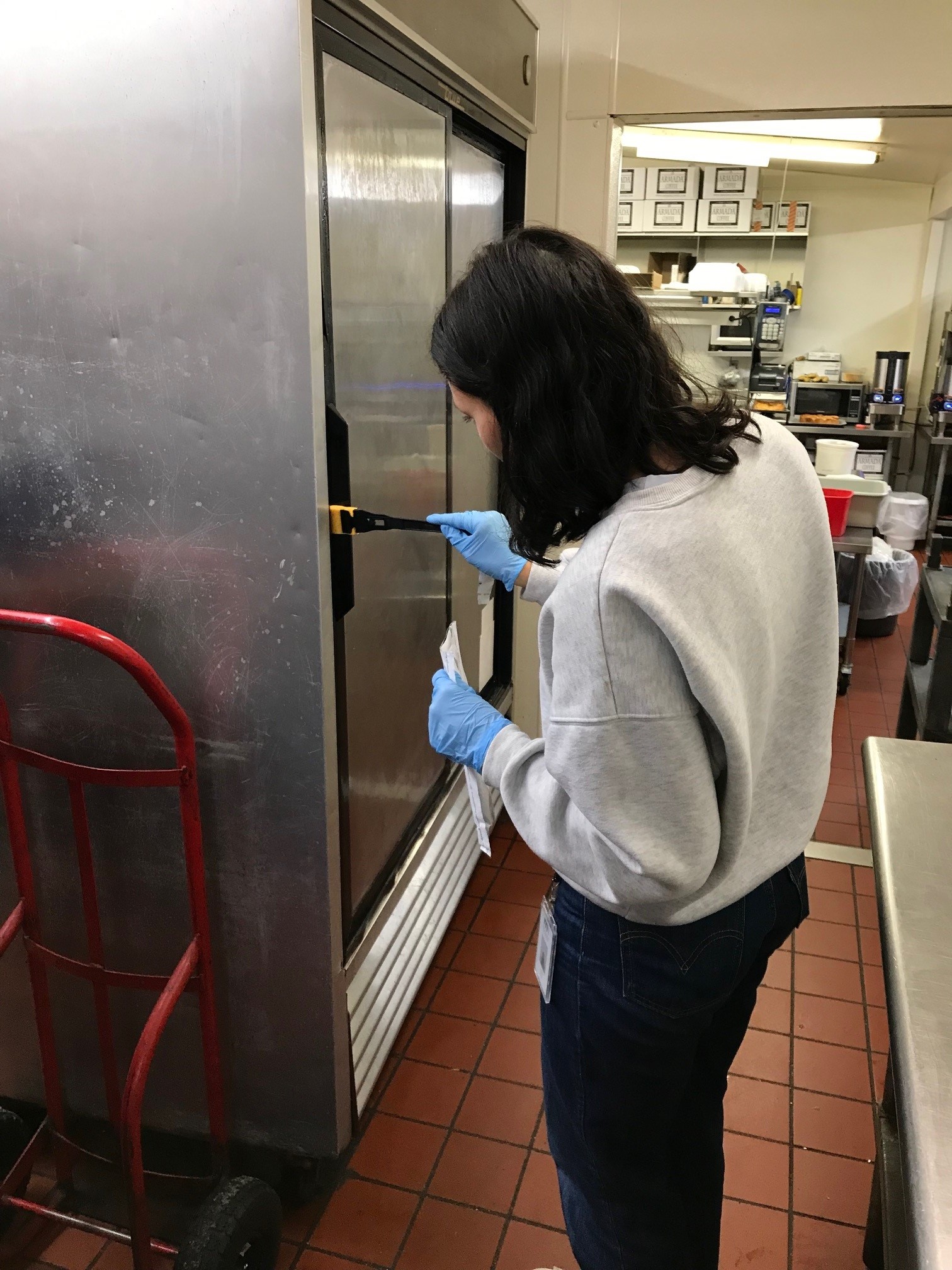 EIS officer Emily Silva collects environmental samples while investigating a Salmonella outbreak at a restaurant in Minnesota.