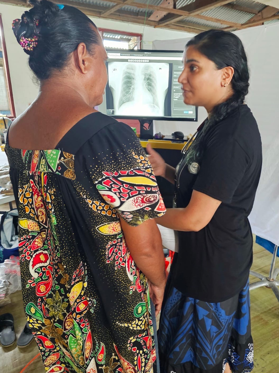 EIS officer Minal Ahson (Class of 2023) explains the result of a chest x-ray screening for TB to a patient in the Federated States of Micronesia, June 2024.