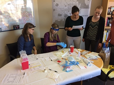 Group of EEP students looking at a sameple of urine culture.