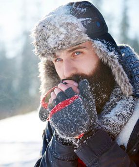 Un hombre calentándose las manos frías. Un hombre calentándose las manos frías.