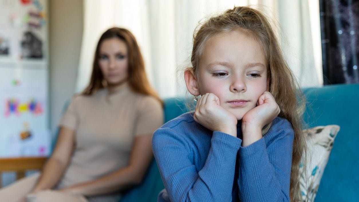 Child looking sad in front of a parent or caregiver