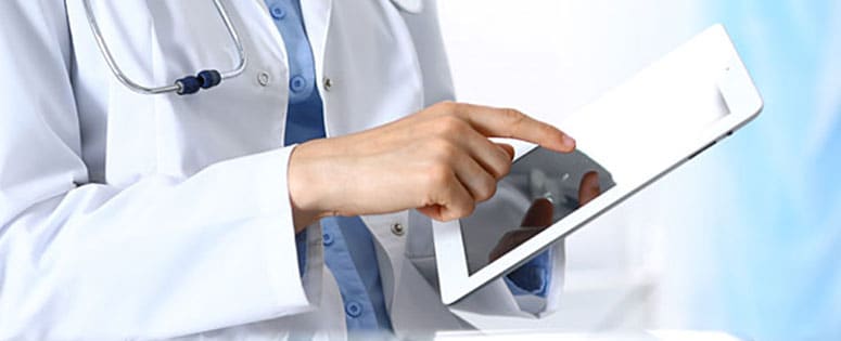 A doctor holding a tablet.