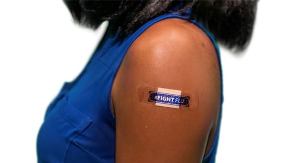 woman with band aid that has text #fightflu
