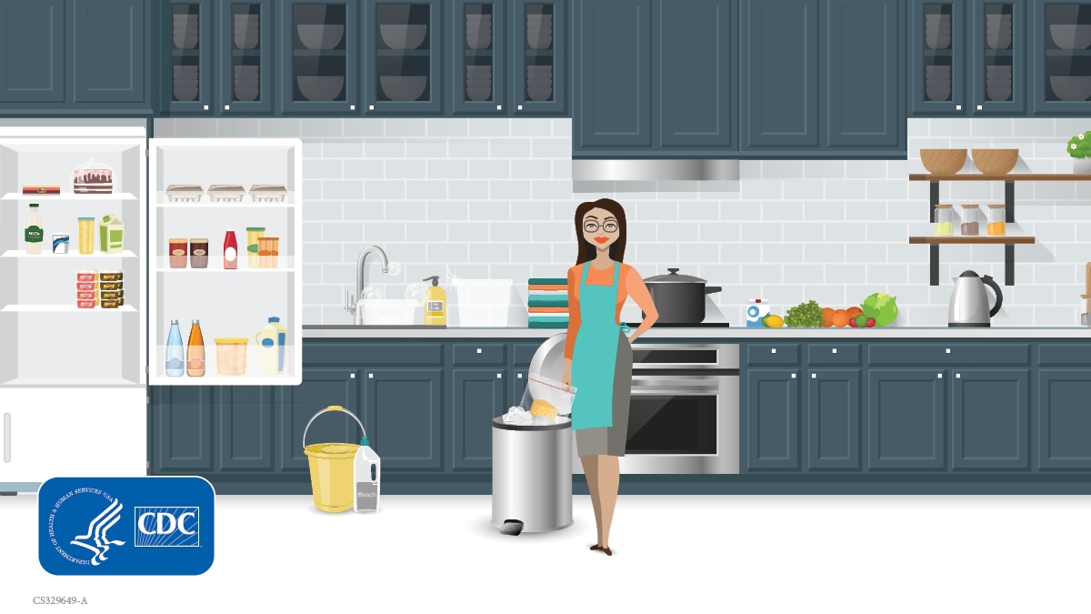 Woman in kitchen cleaning out refrigerator
