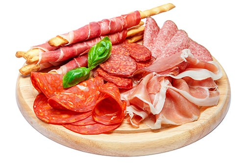 charcuterie board with multiple sliced meats