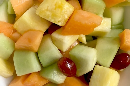 cut up pineapple, honeydew, and cantaloupe