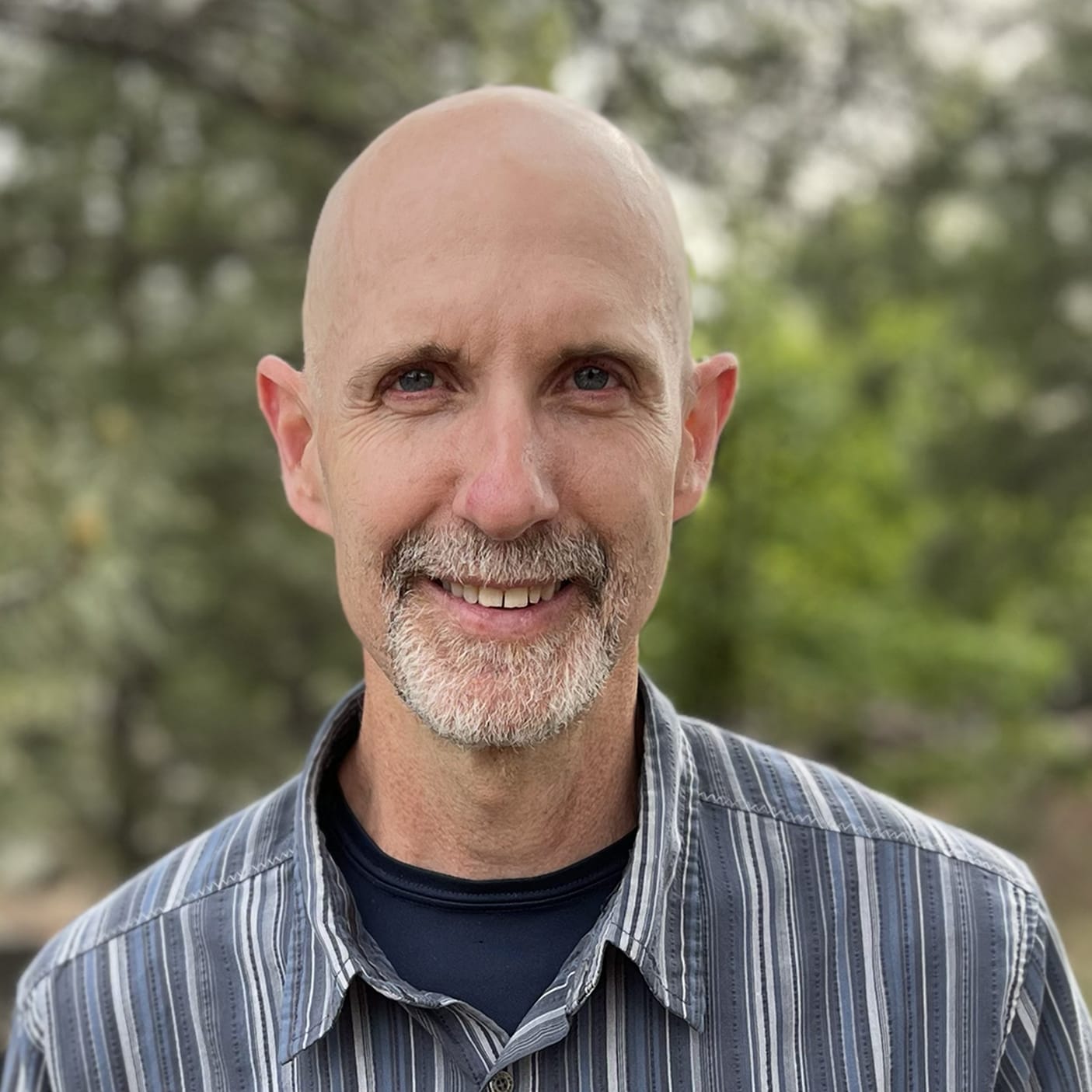 Eric Rescorla, CFA's Chief Technologist, wears a blue and white striped button down with a black undershirt.