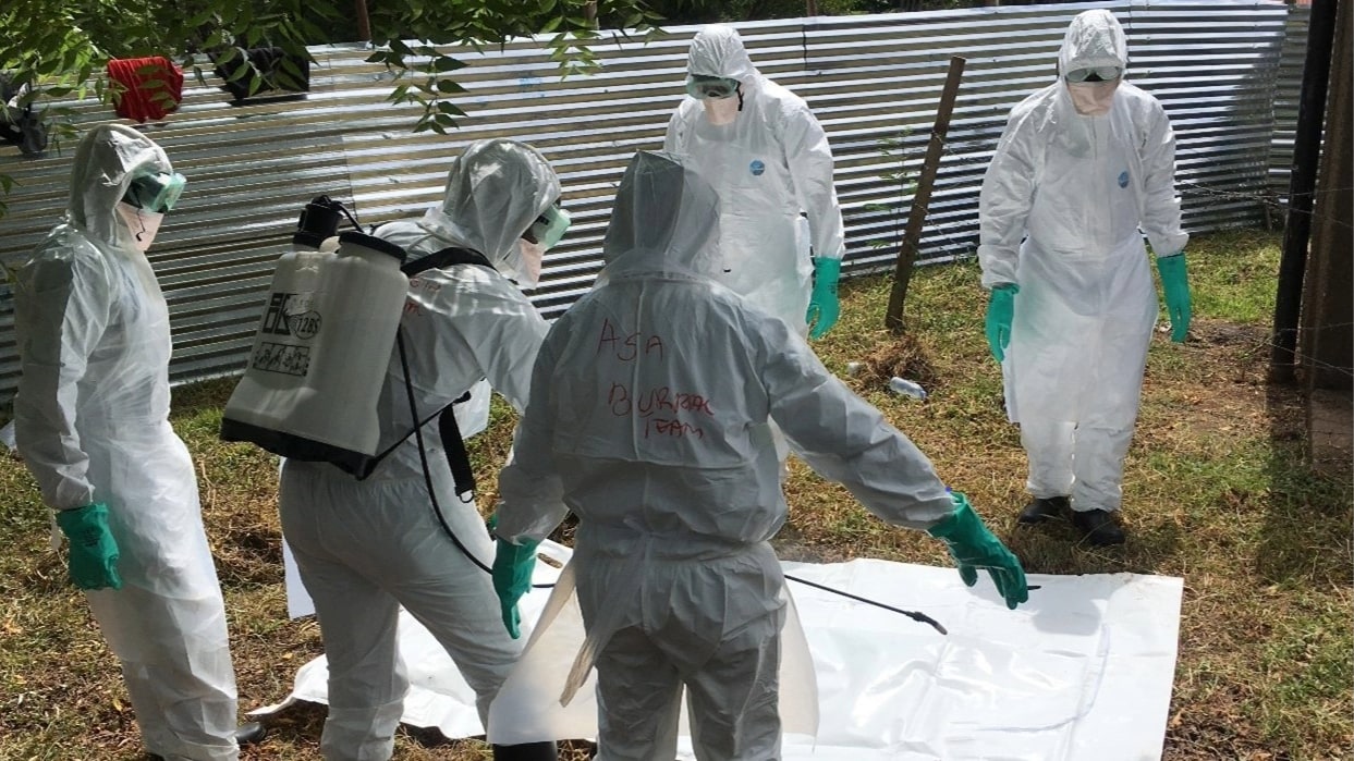 A burial team simulates proper safe burial procedures during a simulation exercise