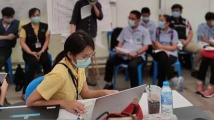 Dr. Ern and Department of Disease Control Thailand staff and healthcare personnel during a COVID-19 outbreak daily briefing